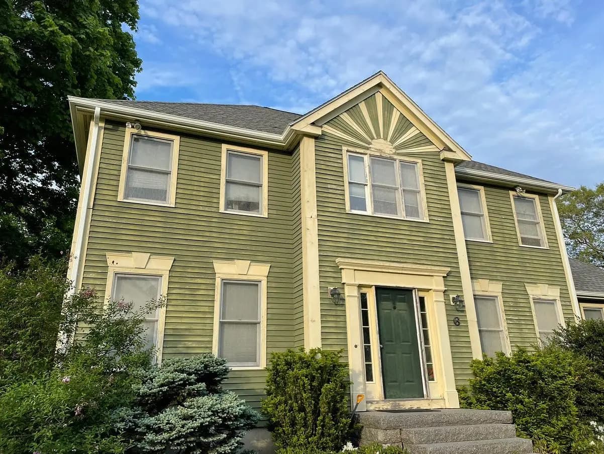 Colonial home entry with evergreen foundation plantings on Cape Cod